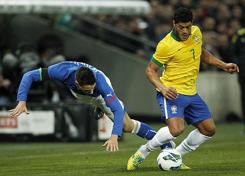Italy's Mattia De Sciglio is tackled by Brazil's Hulk as they vie for possession during their international friendly at the Stade de Geneve in Geneva on Thursday