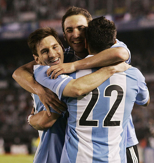 Argentina's Gonzalo Higuain (centre) celebrates with teammates Leonel Messi (left) and Ezequiel Lavezzi after he scored their third goal against Venezuela in a 2014 World Cup qualifying match in Buenos Aires on Friday