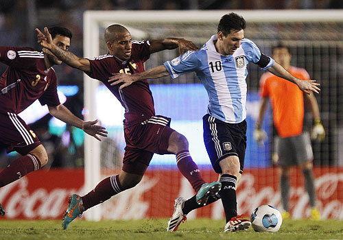 Argentina's Leonel Messi is chased by Venezuela's Romulo Otero (centre) and Andres Tunez (left) during their World Cup qualifying match in Buenos Aires on Friday