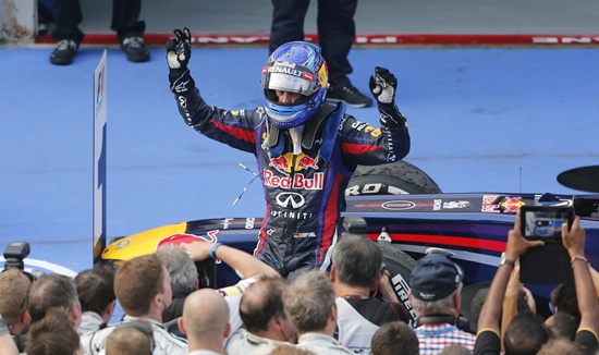 Red Bull Formula One driver Sebastian Vettel celebrates winning