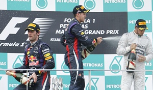 Sebastian Vettel (centre), teammmate Mark Webber and Lewis Hamilton of Britain (right)