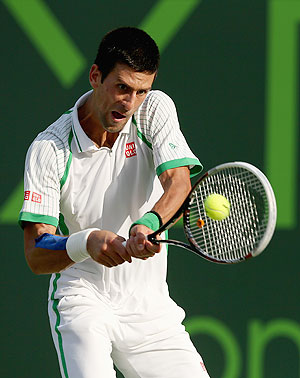 Novak Djokovic of Serbia plays a backhand against Somdev Devvarman of India during their third round match at the Miami Masters at Crandon Park Tennis Center in Key Biscayne, Florida on Sunday