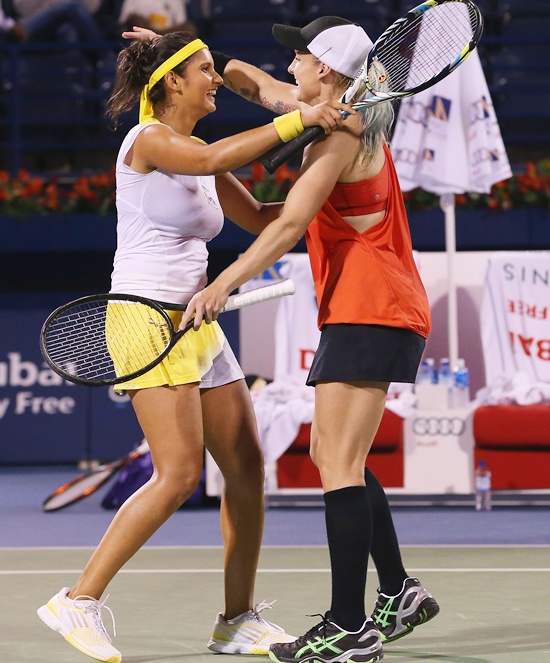 Bethanie Mattek-Sands of USA (right) celebrates winning the match with partner Sania Mirza