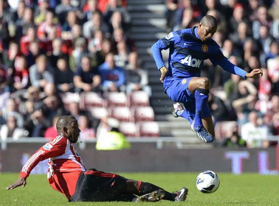 Sunderland's Titus Bramble (left) challenges Manchester United's Ashley Young
