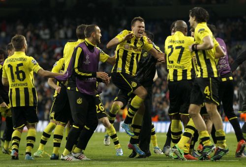 Borussia Dortmund players celebrate after the Champions League semi-final second leg soccer match against Real Madrid at Santiago Bernabeu stadium in Madrid
