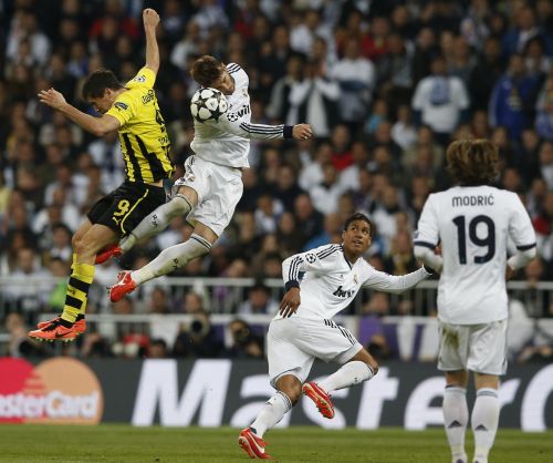 Real Madrid's Sergio Ramos (2nd L) and Borussia Dortmund's Robert Lewandowski (L) jump to head the ball during their Champions League semi-final second leg soccer match at Santiago Bernabeu stadium in Madrid