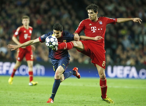 Bayern Munich's Javi Martinez (right) is challenged by Barcelona's Marc Bartra