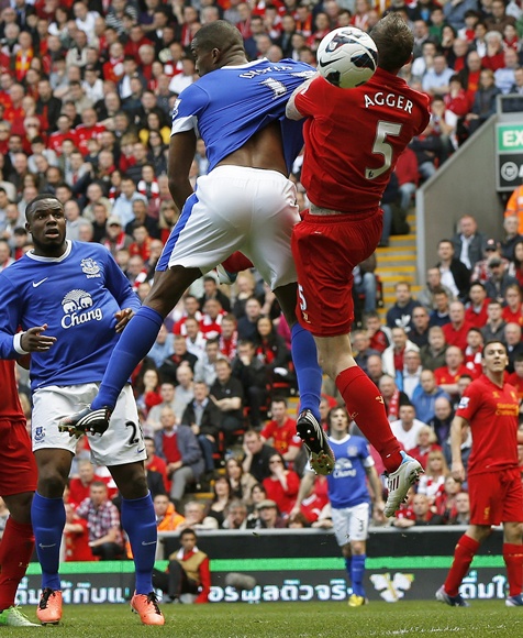 Liverpool's Daniel Agger (right) challenges Everton's Sylvain Distin