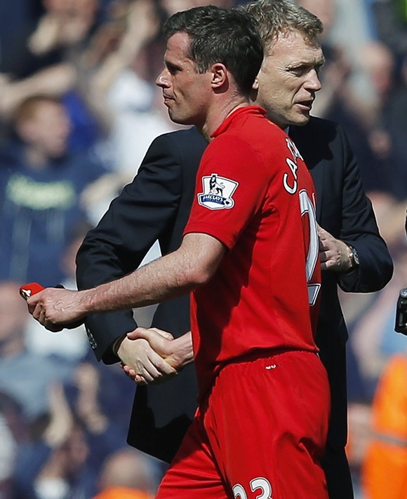 Everton's manager David Moyes (right) shakes hands with Liverpool's Jamie Carragher