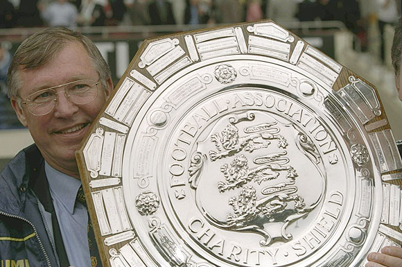 Alex Ferguson, the Manchester United manager holding the FA Charity Shield after victory against Chelsea at Wembley Stadium in London, England