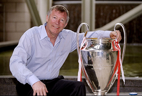 Manchester United manager Alex Ferguson shows off the European Cup on his return to Manchester after victory in the UEFA Champions League final over Bayern Munich in 1999