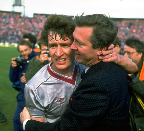 Alex Ferguson Manager of Aberdeen hugs Sandy Jardine (left) of Hearts after winning the Scottish Cup final in Glasgow, in 1986