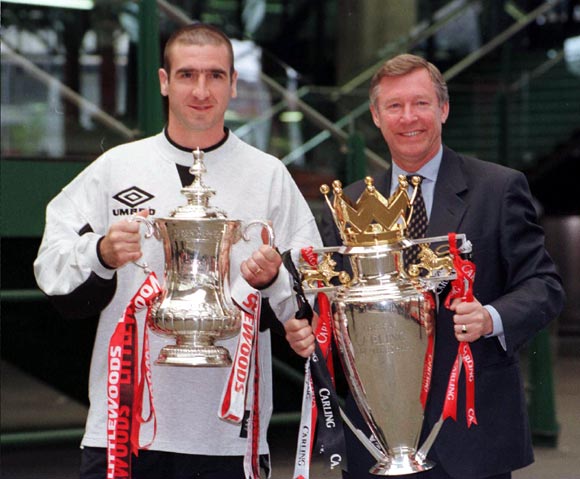 Manchester United manager Alex Ferguson (right) and Eric Cantona with the FA Cup and Premiership trophy