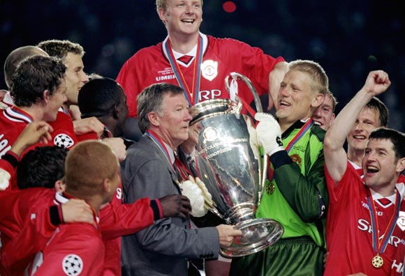Alex Ferguson celebrates with his team after winning the Champions League in 1999