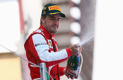 Fernando Alonso of Spain and Ferrari celebrates on the podium after winning the Spanish Formula One Grand Prix at the Circuit de Catalunya on Sunday