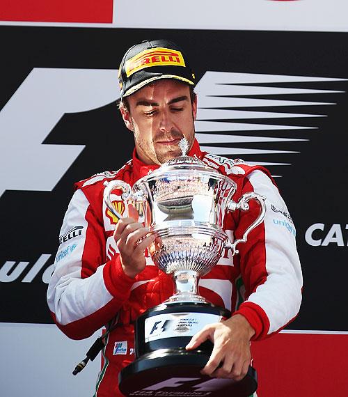 Fernando Alonso of Spain and Ferrari celebrates on the podium after winning the Spanish Formula One Grand Prix at the Circuit de Catalunya on Sunday