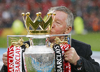 Manchester United manager Alex Ferguson poses with the English Premier League trophy at Old Trafford stadium in Manchester on Sunday. Ferguson's last home match in charge of Manchester United ended in a low-key 2-1 Premier League win over Swansea City as the Old Trafford crowd gave their long-serving manager a warm and emotional send-off on Sunday