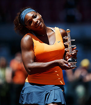 Serena Williams poses with the trophy after defeating Maria Sharapova in the final of the Madrid Open tennis tournament on Sunday