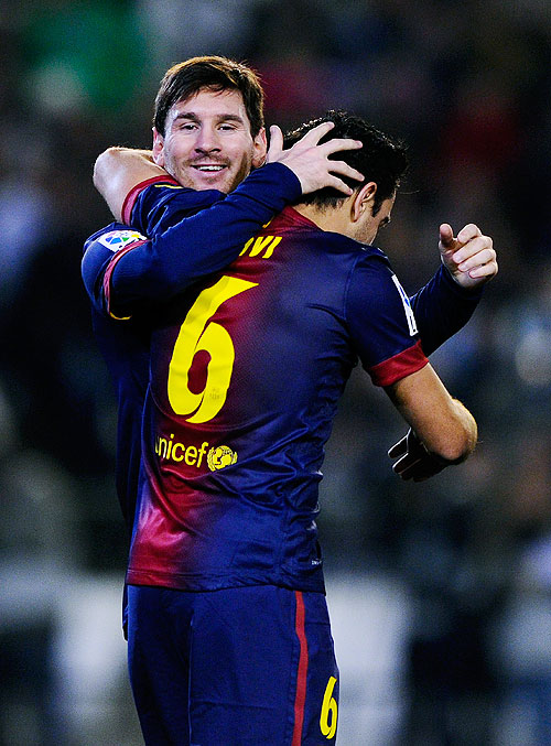 Lionel Messi of FC Barcelona (right) celebrates with teammate Xavi Hernandez