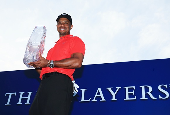 Tiger Woods of the USA holds the winner's trophy