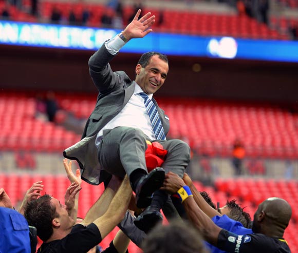 Wigan Athletic manager Roberto Martinez celebrates with his players after winning the FA Cup