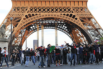 Fans gesture as they face riot Gendarmes in front of the Eiffel Tower on Monday