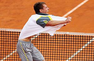 Jerzy Janowicz of Poland rips his shirt after his straight sets victory against Jo-Wilfried Tsonga of France on Wednesday