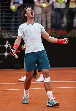 Rafael Nadal of Spain celebrates after his three set victory against Ernests Gulbis of Latvia in their third round match of the Rome Masters on Thursday
