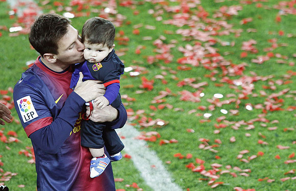 Messi kisses his son Thiago at the presentation ceremony on Sunday