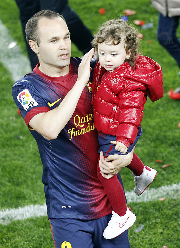 Barcelona's Andres Iniesta with his daughter Valeria during La Liga title celebrations at Camp Nou stadium in Barcelona on Sunday