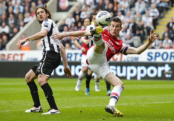 Arsenal's Lourent Koscielny (right) scores against Newcastle United during their English Premier League soccer match at St James' Park in Newcastle on Sunday