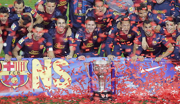 Barcelona's players pose with the La Liga trophy during celebrations at Camp Nou stadium in Barcelona on Sunday