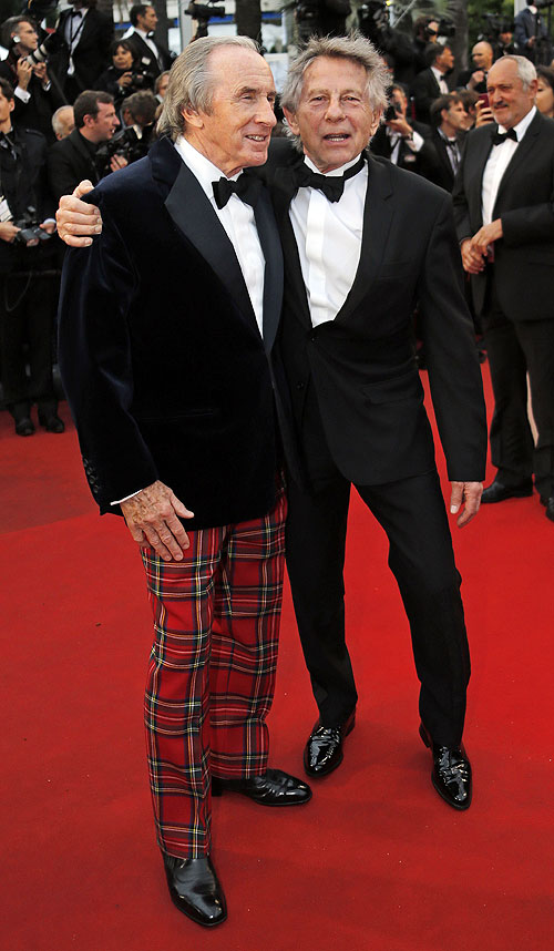 Director Roman Polanski (right) and former Formula One champion driver Jackie Stewart of Britain pose on the red carpet as they arrive for the screening of the film