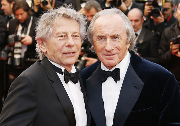 Director Roman Polanski (left) and former Formula One champion driver Jackie Stewart of Britain pose on the red carpet as they arrive for the screening of the film