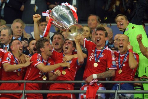 Philipp Lahm of Bayern Muenchen lifts the trophy after winning the UEFA Champions League final match against Borussia Dortmund at Wembley Stadium
