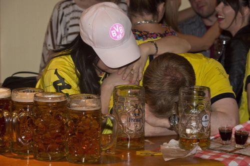Borussia Dortmund fans in a Bavarian bar in London react as their team loses 2 -1 against Bayern Munich