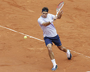 Roger Federer of Switzerland hits a return to Pablo Carreno-Busta of Spain during their first round match of the French Open at the Roland Garros on Sunday