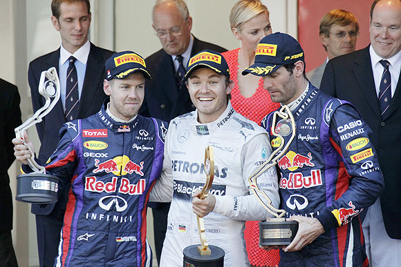 Mercedes'Nico Rosberg celebrates next to Red Bull's Sebastian Vettel (2nd) and Mark Webber (3rd) after winning the Monaco F1 Grand Prix on Sunday
