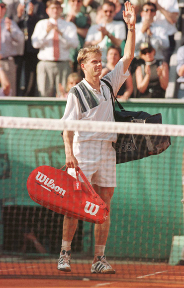 Stefan Edberg of Sweden waves goodbye to the crowd as his last appearance at the French Open