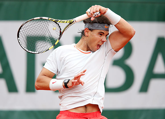 Rafael Nadal plays a forehand against Martin Klizan of Slovakia during the second roubd at the French Open at Roland Garros on Thursday