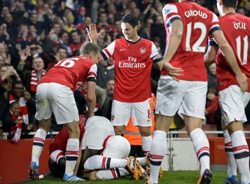 Arsenal players celebrate after winning a team