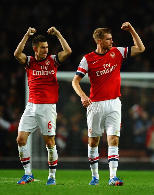 Laurent Koscielny of Arsenal and Per Mertesacker of Arsenal celebrate victory