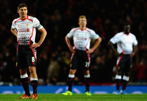A dejected Steven Gerrard of Liverpool looks to the big screen after they conceded a second goal