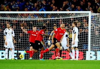 Steven Caulker of Cardiff City (2R) celebrates scoring