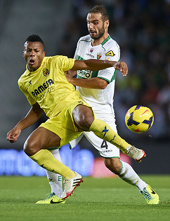 David Lomban (right) of Elche is challenged by Ikechukwu Uche of Villarreal during their La Liga match at Estadio Manuel Martinez Valero in Elche on Monday