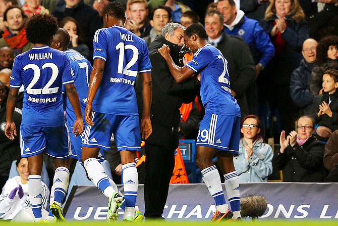 Samuel Eto'o of Chelsea celebrates with team manager Jose Mourinho after scoring the opening goal of their UEFA Champions League Group E match against FC Schalke 04 at Stamford Bridge in London on Wednesday