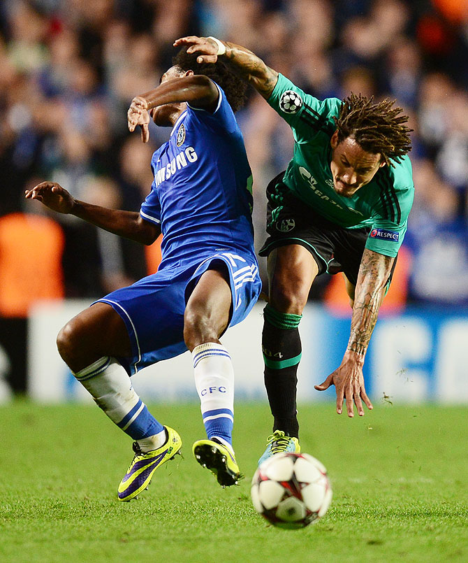 Willian of Chelsea and Jermaine Jones of Schalke collide during the UEFA Champions League Group E match at Stamford Bridge in London on Wednesday