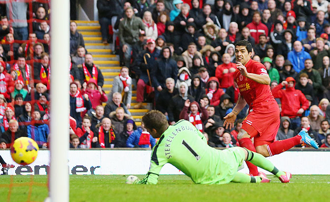 Luis Suarez of Liverpool scores the third goal during their Premier League match against Fulham at Anfield on Saturday
