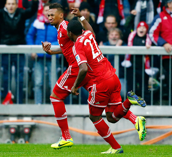 Bayern Munich's Jerome Boateng celebrates with David Alaba (right) after scoring against FC Augsburg during their Bundesliga match in Munich on Saturday