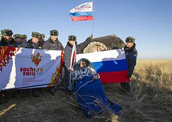 International Space Station (ISS) crew member Russian cosmonaut Fyodor Yurchikhin holds the torch of the 2014 Sochi Winter Olympic Games after landing near the town of Zhezkazgan in central Kazakhstan on Monday